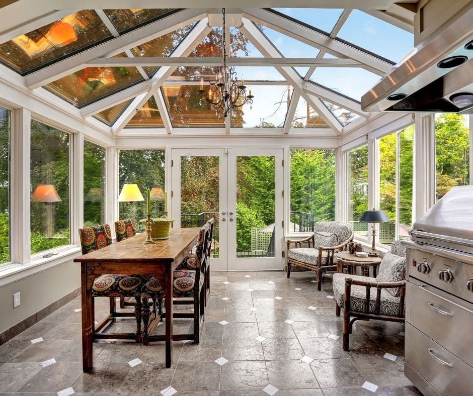 A mostly glass sunroom with places to eat and relax