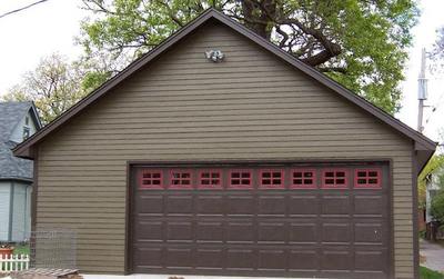 Image of a brown house with a brown garage door