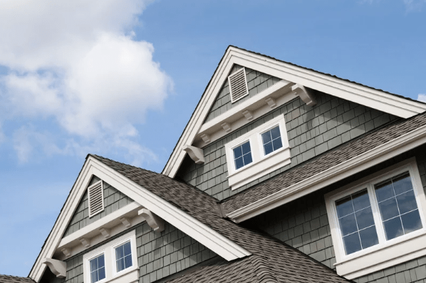 A gray house with vinyl replacement windows